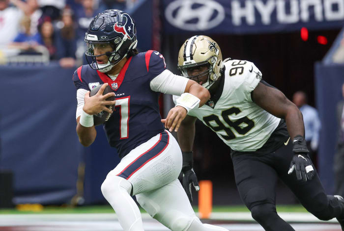 Texans quarterback C.J. Stroud (7) runs with the ball as New Orleans Saints defensive end Carl Granderson (96) defends during the first quarter at NRG Stadium.